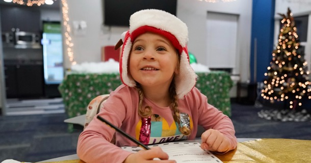 Cutline: A child prepares a letter for Santa at NPCC’s Santa’s Workshop last year. This year’s event is scheduled for Dec. 3.